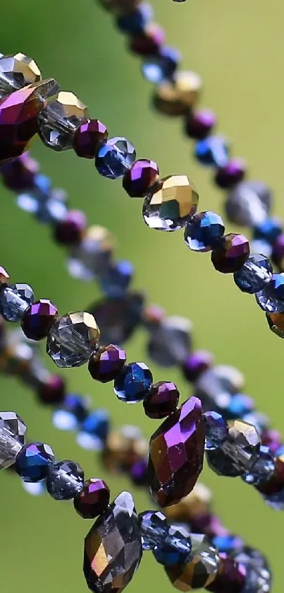 Vibrant spiral art with colorful beads against a green background.