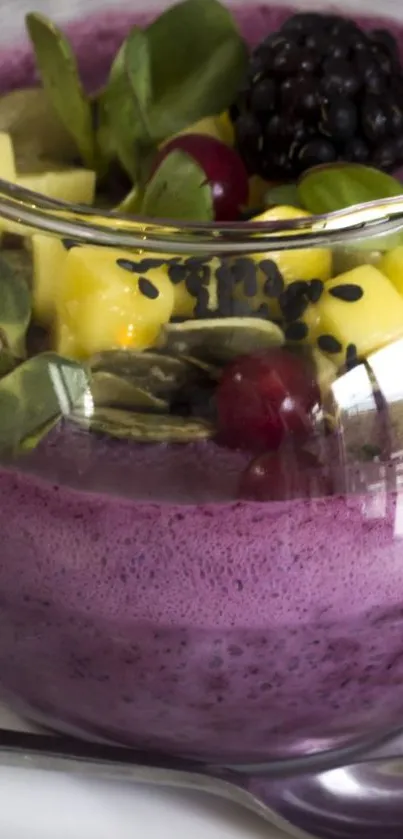 Purple smoothie bowl with fruit and seeds.