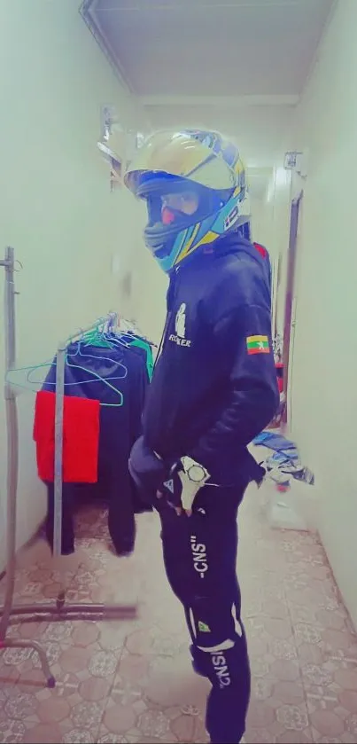 Biker in colorful gear standing in a hallway.