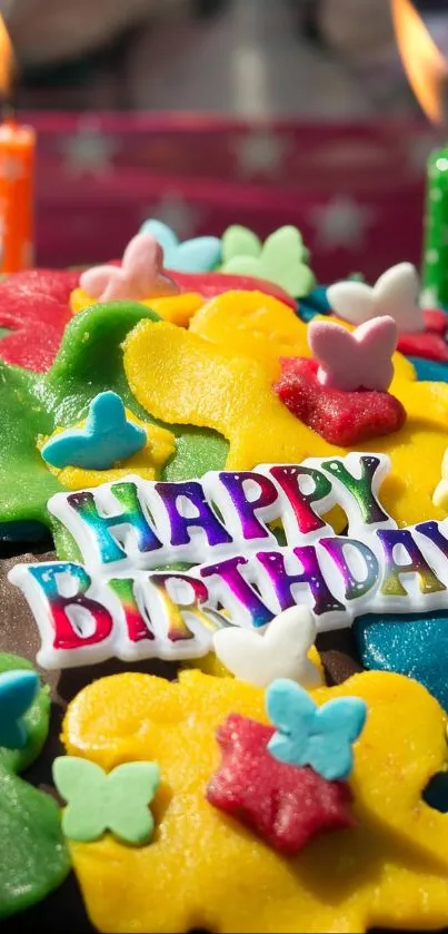 A colorful birthday cake with vibrant flowers and lit candles.