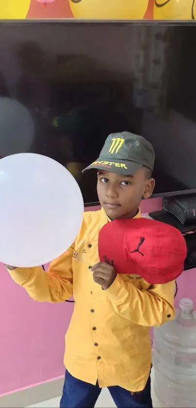 Boy holding balloons in a festive birthday setting.