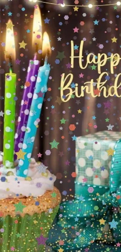 A colorful birthday cake with lit candles and a gift box.