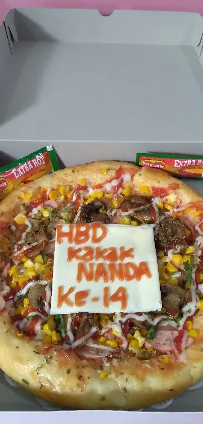 Birthday-themed pizza with colorful toppings in a pizza box.