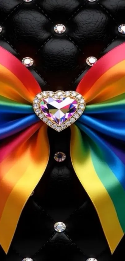 Rainbow bow with gemstone heart on black background.