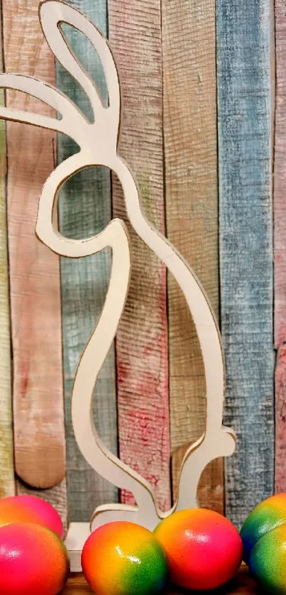 Bunny silhouette with colorful eggs on a wooden backdrop.
