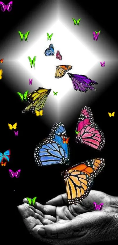 Artistic wallpaper with colorful butterflies on a black background and hands releasing them.