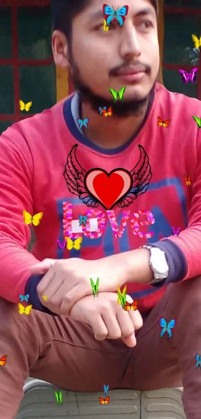 Person in red shirt with butterflies and heart design.