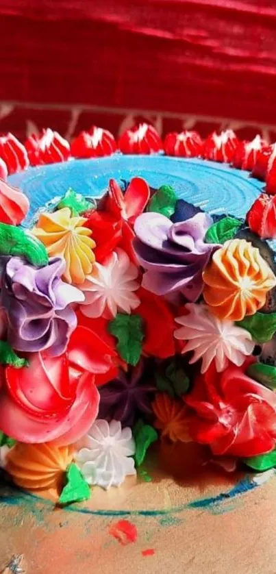 A vibrant floral cake with colorful icing on a red background.