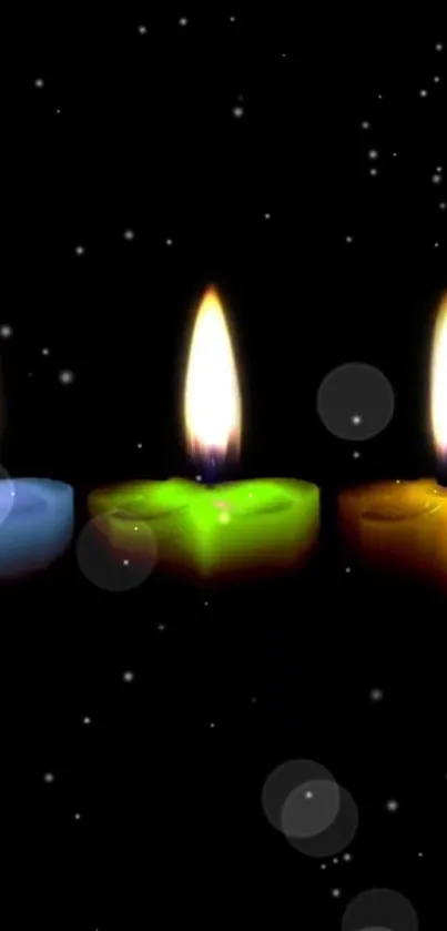 Three colorful candles glowing against a starry black background.