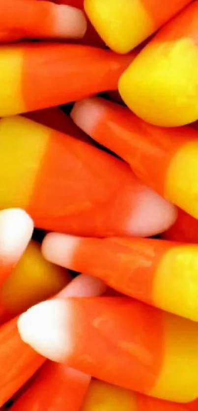 Colorful candy corn wallpaper with vibrant orange, yellow, and white hues.