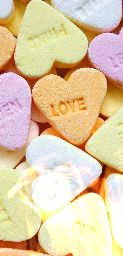 Colorful candy hearts scattered in a random pattern.