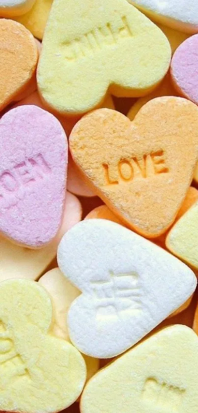 Colorful candy hearts with love messages in pastel hues.