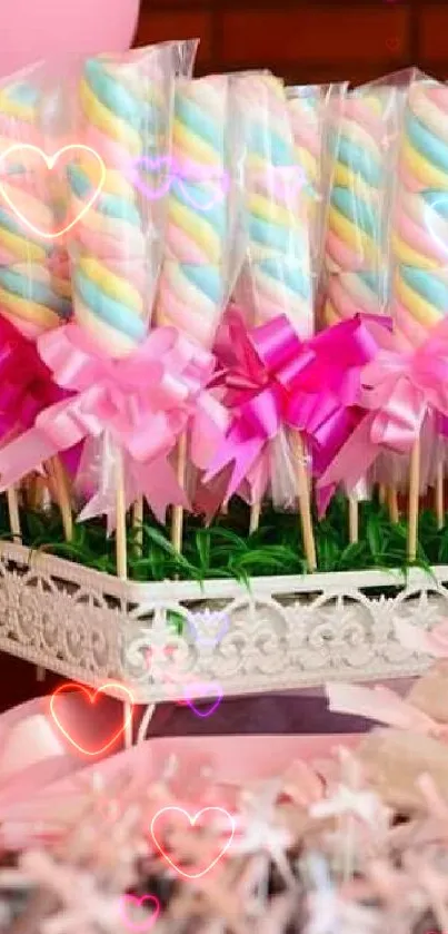 Colorful pastel candy sticks with pink bows displayed elegantly.