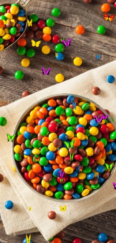 Bowl of colorful candies on wood surface.