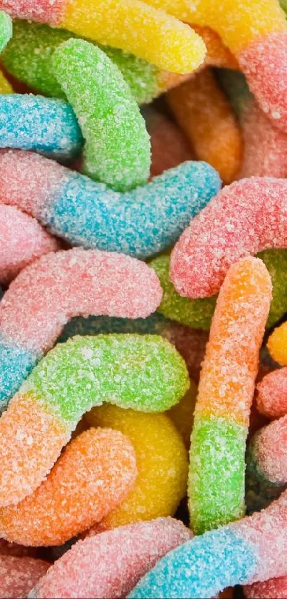 Colorful gummy worms with sugar coating, vibrant wallpaper.