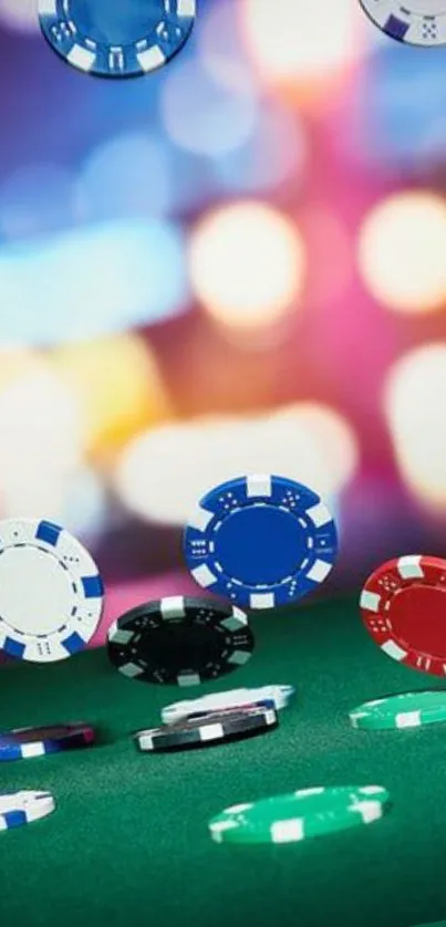 Vibrant casino poker chips on a green table with colorful bokeh background.