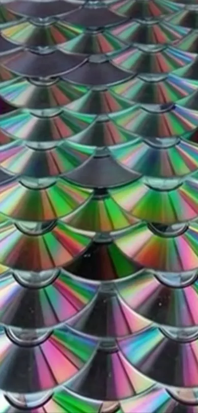 A pattern of overlapping CDs creating vibrant rainbow reflections.