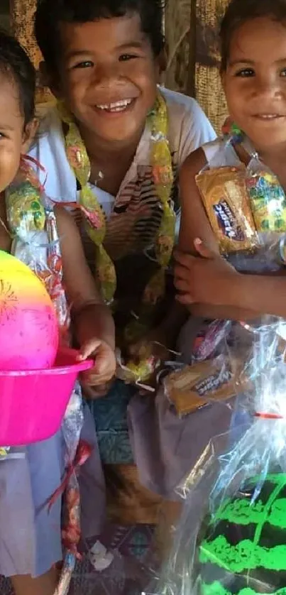 Three smiling children with colorful decorations in a joyful celebration scene.