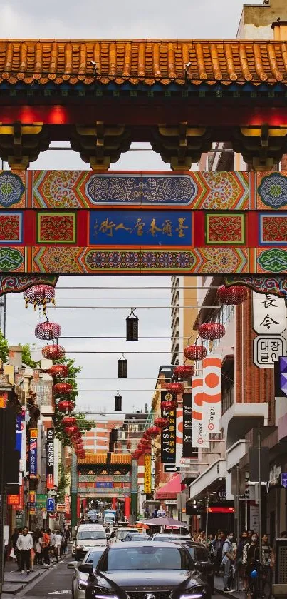 Vibrant Chinatown gateway with street view and red lanterns.