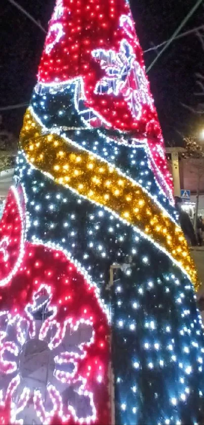 Bright Christmas tree with colorful lights at night.