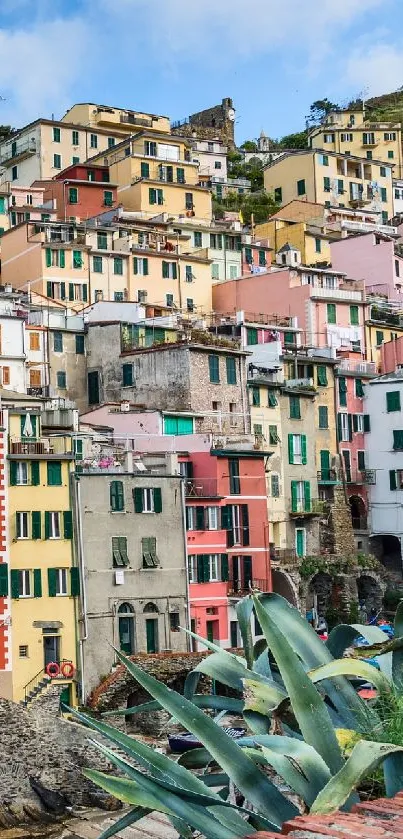 Vibrant cliffside village with ocean view and colorful houses.