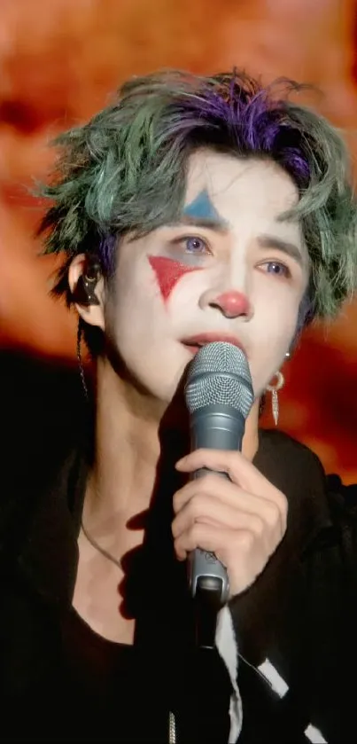 Performer in colorful clown makeup holding a microphone.