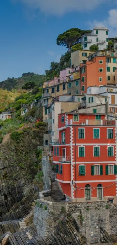 Vibrant coastal town with cliffside and ocean.