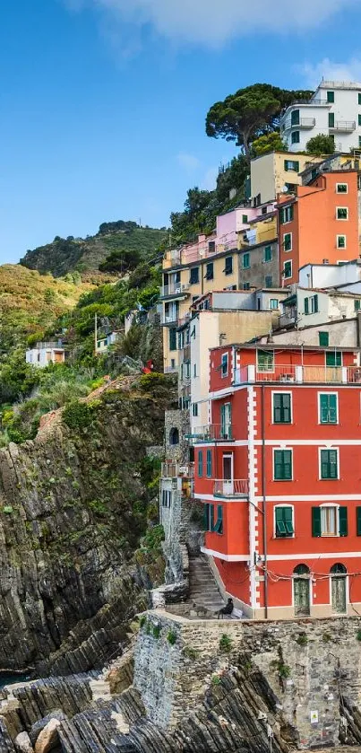 Colorful cliffside village overlooking the sea with vibrant houses and blue skies.