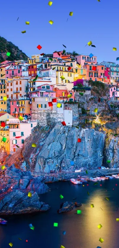 Cinque Terre houses lit up at dusk against a vibrant sky.