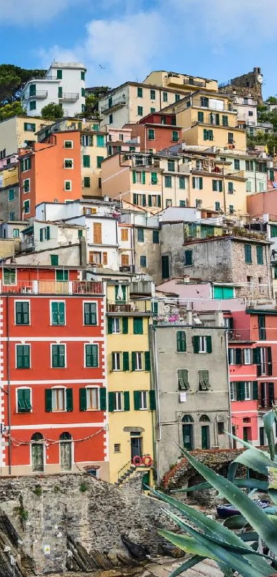 Colorful coastal town with hillside homes and ocean view.