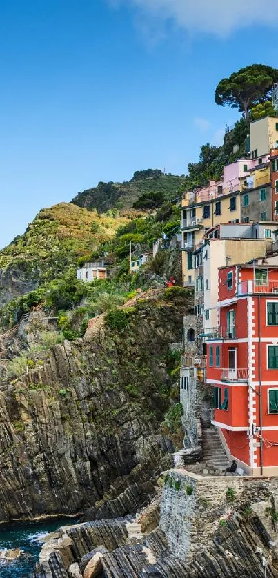 Vibrant coastal town with colorful buildings against a seaside cliff.