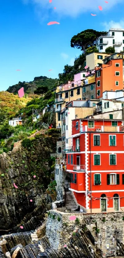 Vibrant coastal village with colorful houses beside a bright blue sea.