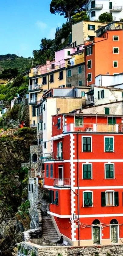 Vibrant coastal village with colorful buildings on cliffs.