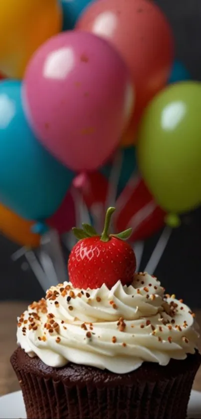 Cupcake with strawberry and colorful balloons background.