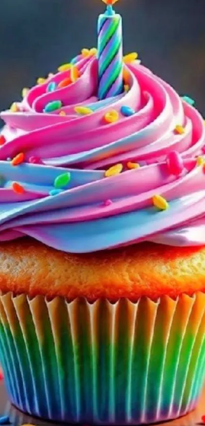 Colorful cupcake with sprinkles and candle.