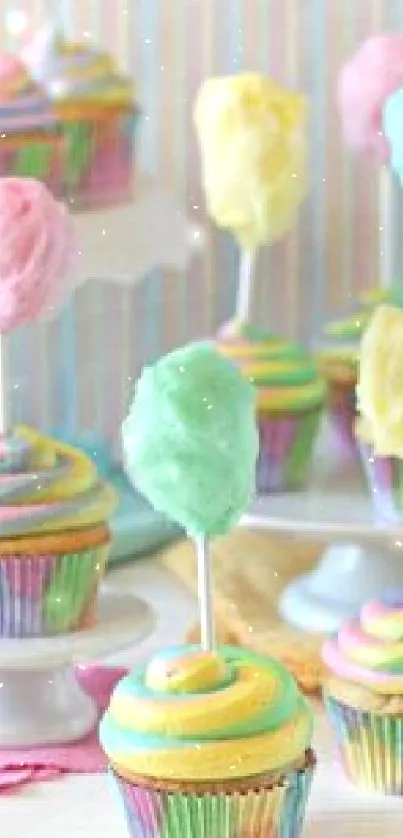 Colorful cupcakes with cotton candy on stands.