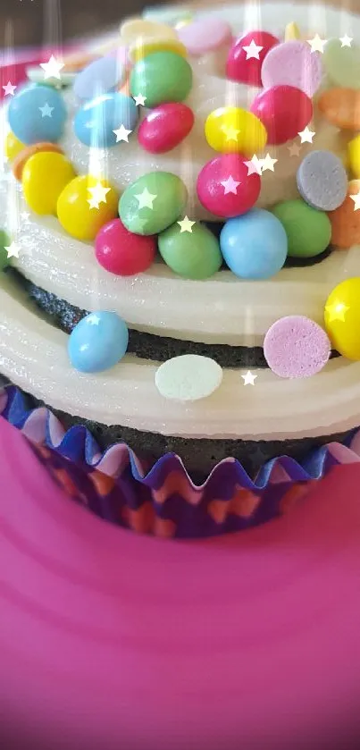 Cupcake with colorful candy sprinkles on a pink plate.