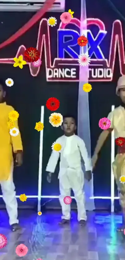 Children in traditional attire dancing at a studio with colorful floral overlay.