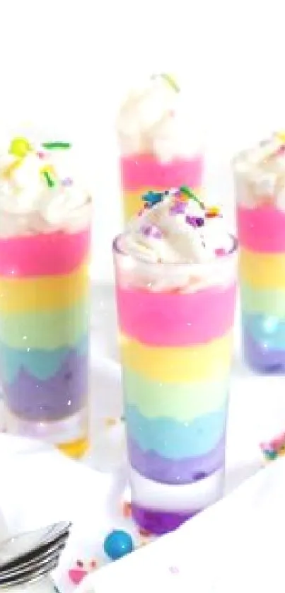 Colorful layered desserts with sprinkles and whipped cream in vibrant hues.