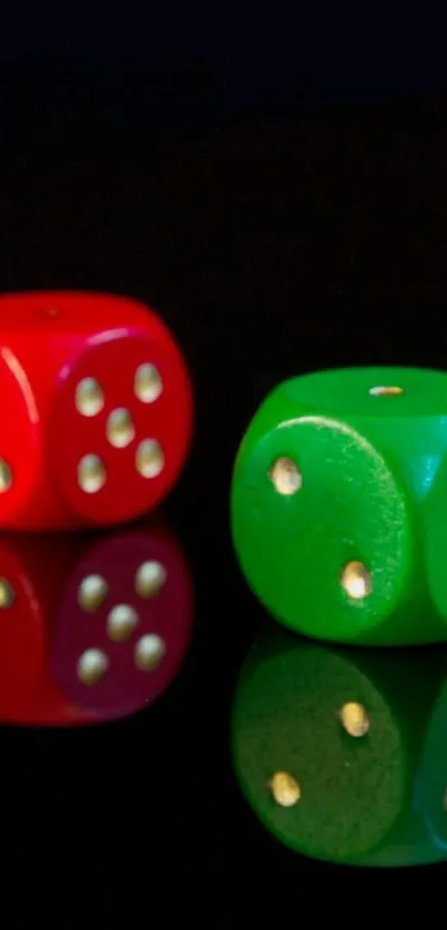 Red and green dice reflected on black.