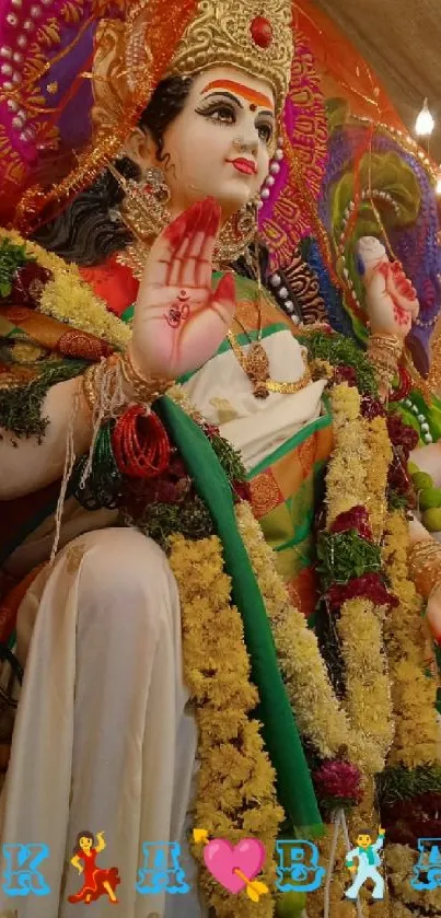 Statue of a divine goddess adorned with colorful decorations.