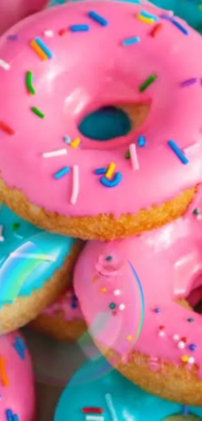 Pink frosted donuts with colorful sprinkles.