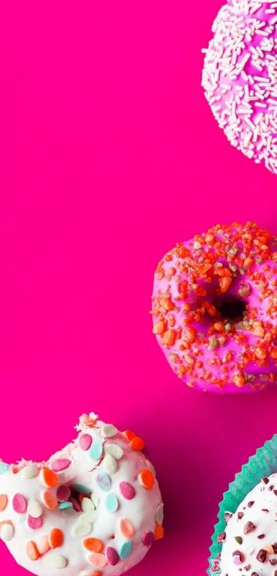 Vibrant pink background with colorful donuts and sprinkles.