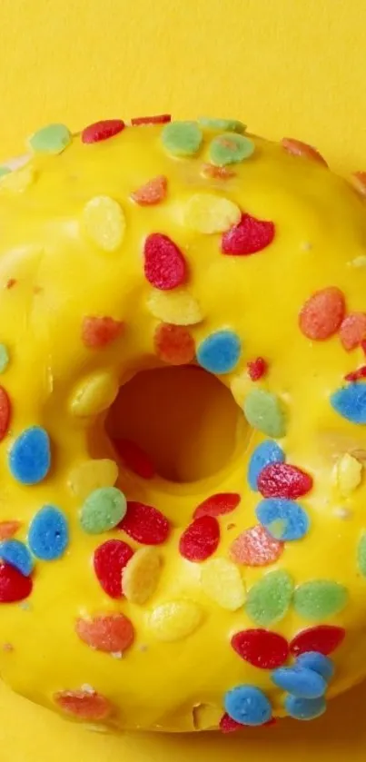 Bright yellow donut wallpaper with colorful sprinkles.