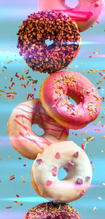 Colorful donuts with sprinkles on turquoise background.