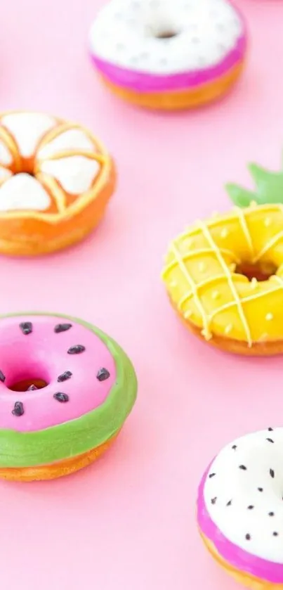 Colorful fruity donuts on pastel pink background wallpaper.