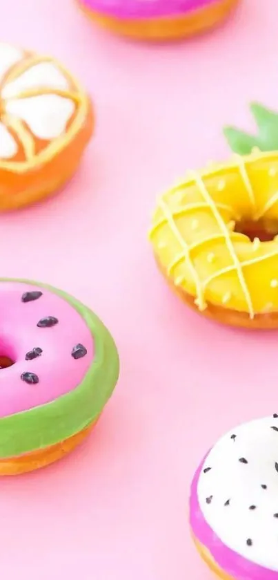 Colorful donuts on a pastel pink background.