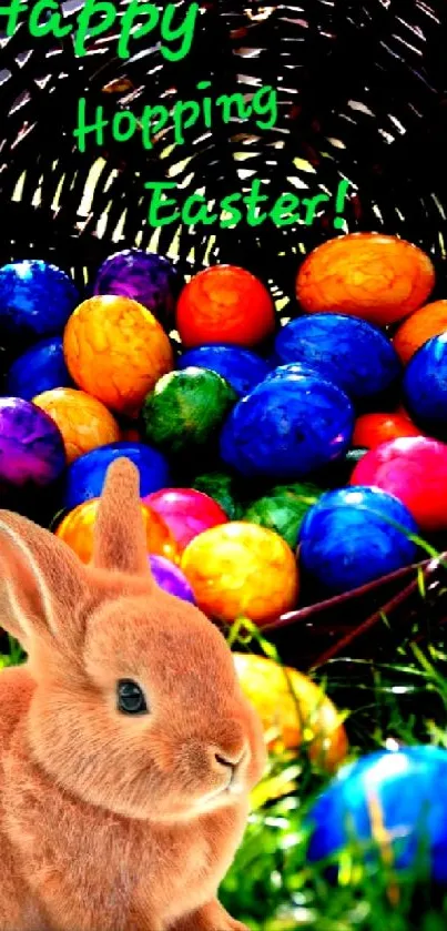 Cute bunny with colorful Easter eggs in a basket on green grass.