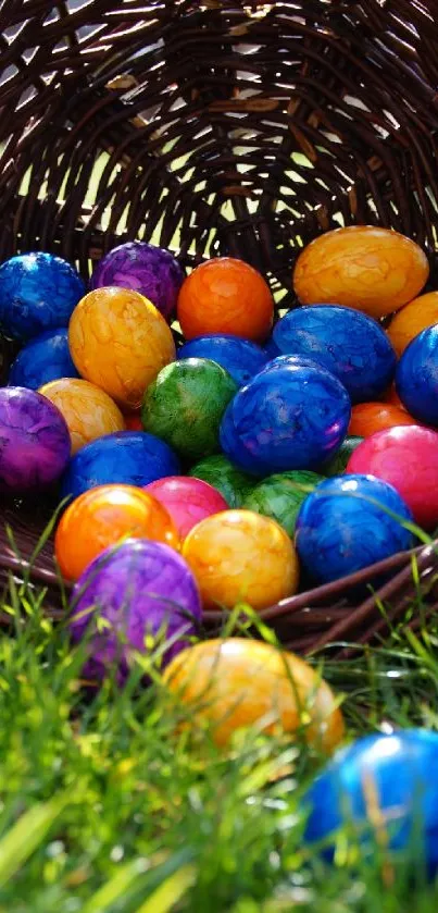 Colorful Easter eggs in a wicker basket on grass.