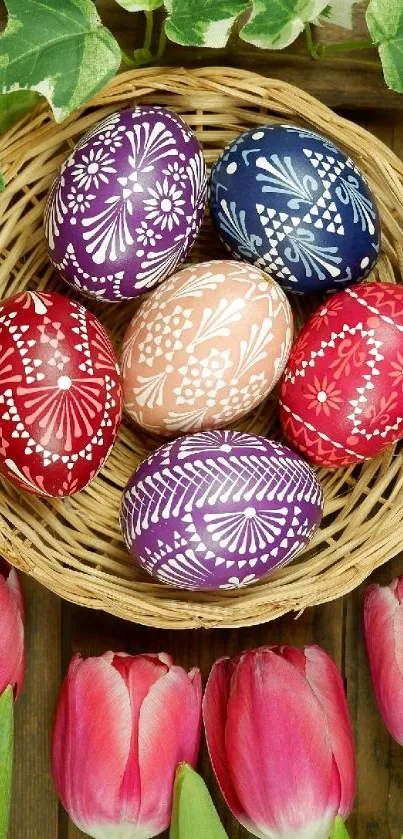 Colorful Easter eggs in a basket with pink tulips on a wooden table.